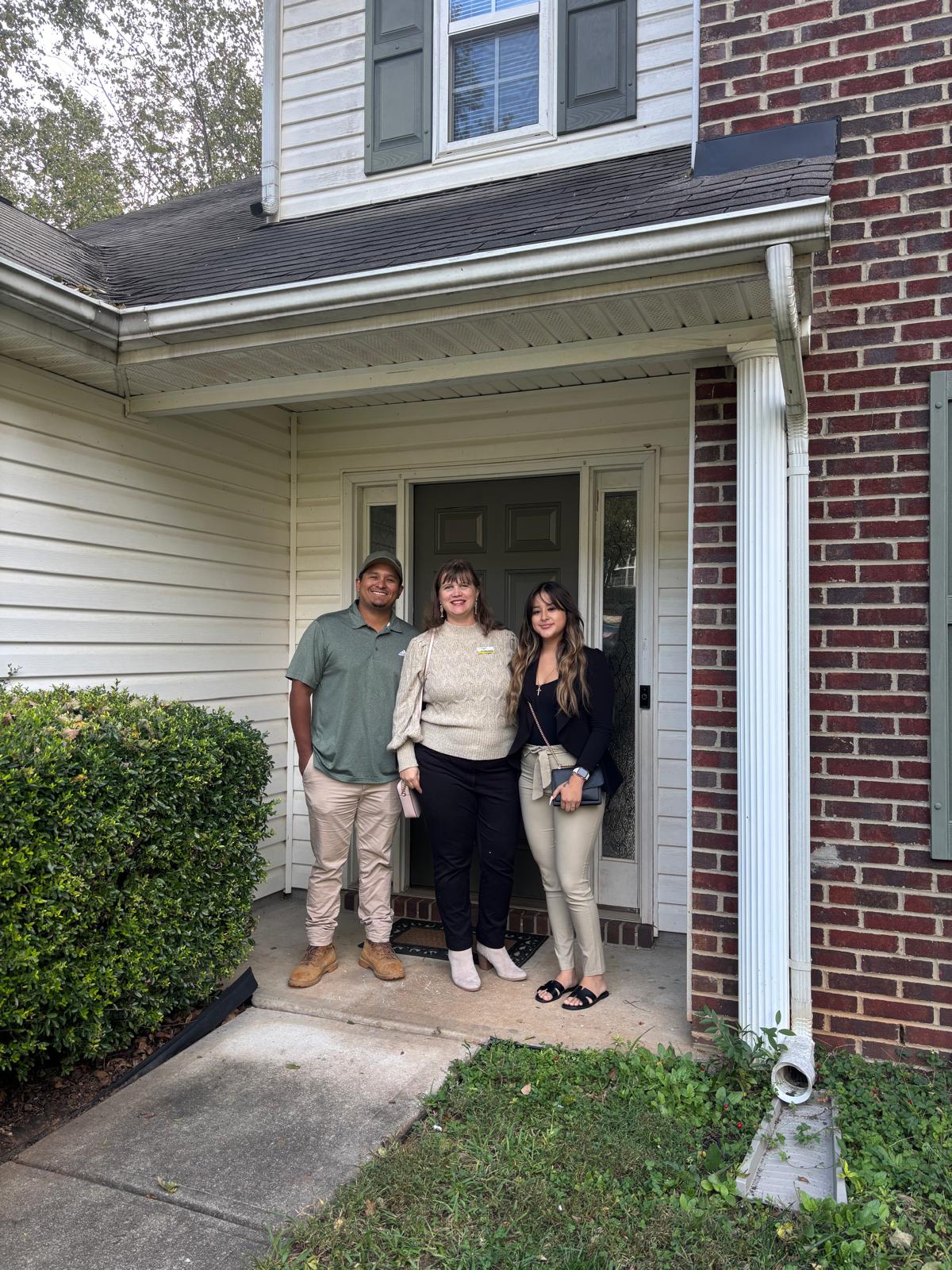 Jeannie Alvear with buyers at their new home door